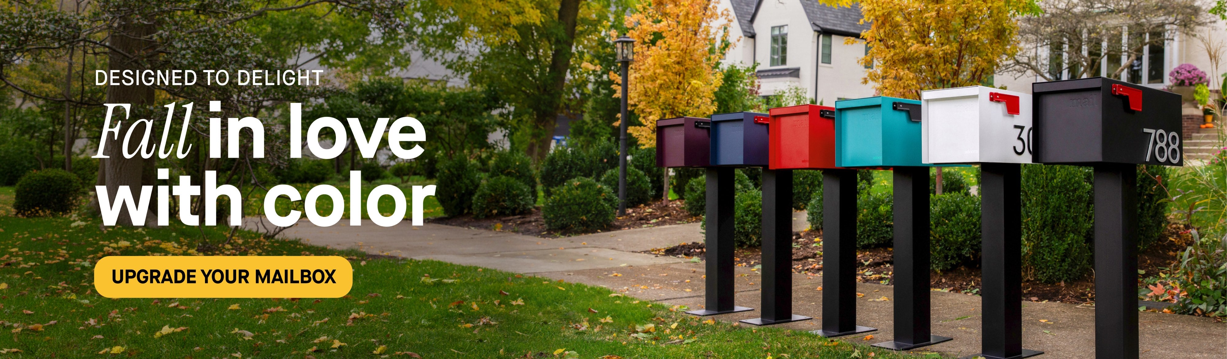 Adoorn mailboxes in purple, navy, red, teal, white, and black lined up on posts along a path with autumn foliage, with the headline Fall in Love With Color and an Upgrade Your Mailbox button.