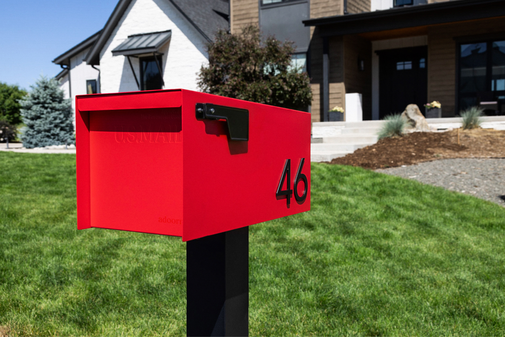 An Adoorn Post Mount mailbox installed at the USPS-recommended 41-45 inch height and 6-8 inch curb setback in a residential setting.