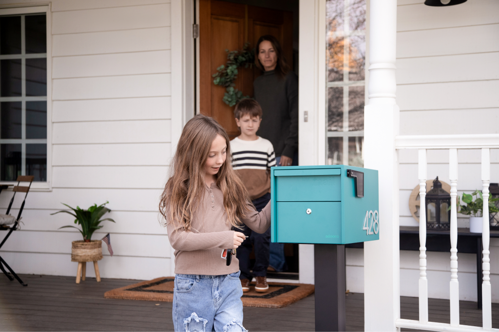 Adoorn Locking Post Mount mailbox at the curb of a residential home, the after side of a before-and-after transformation
