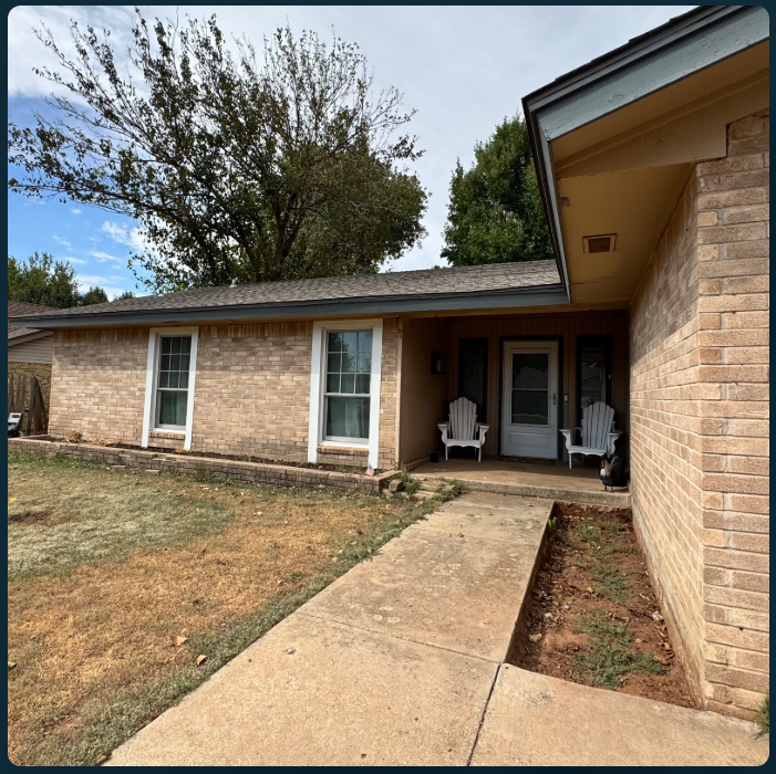 Before: a brick home with a plain concrete walkway, sparse garden beds and white chairs at the covered entry.