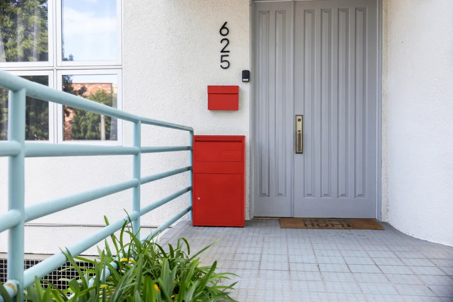 A Red Red Adoorn wall mount, package box, and house numbers bundled at a front door | Adoorn