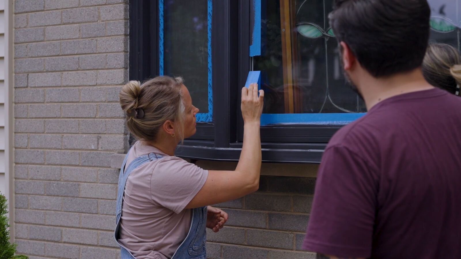 Homeowners comparing color choices at a front door
